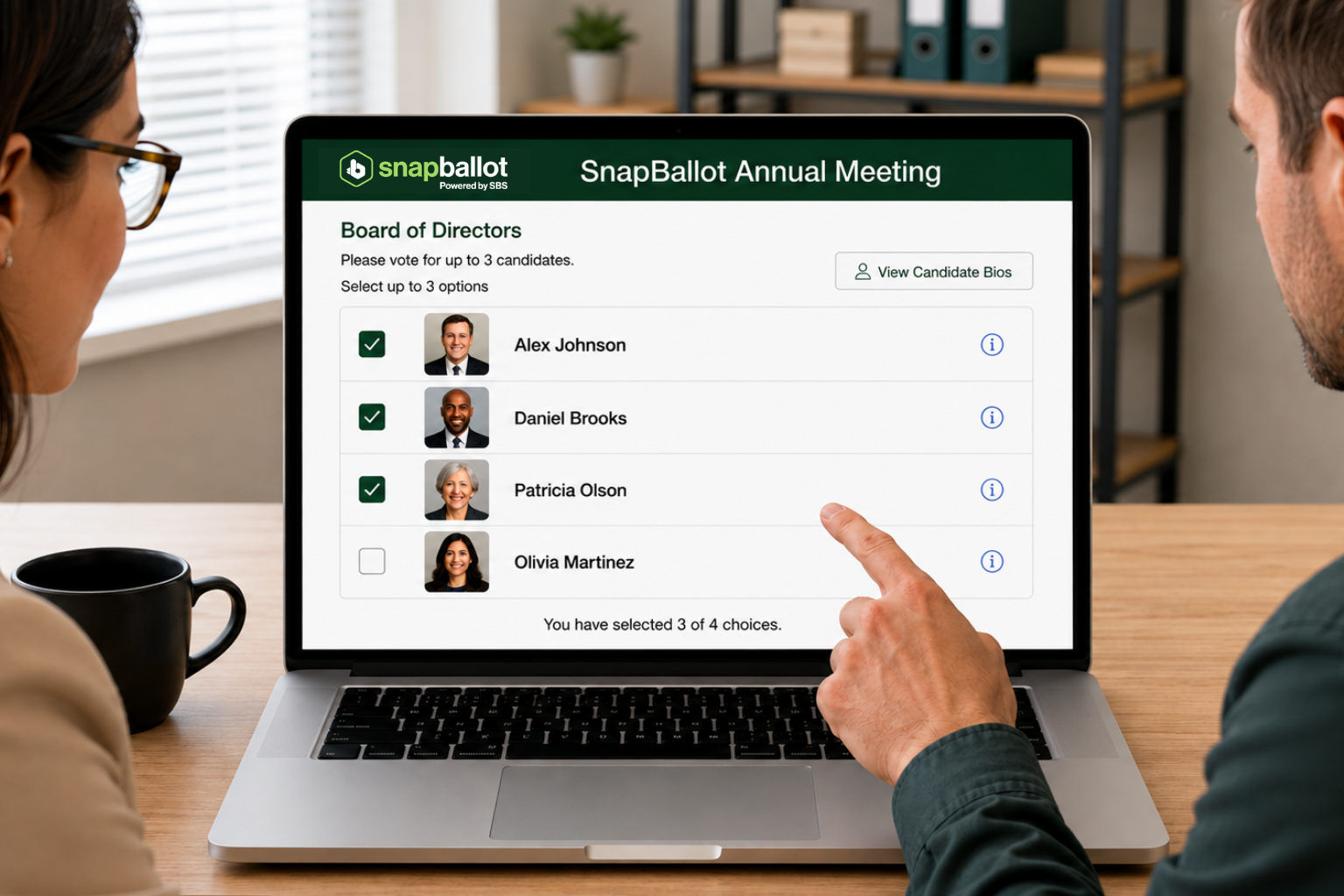 Two people sit at a desk, one pointing at a laptop displaying an HOA Ballot Design for an online voting app tailored for a board of directors election. The screen shows a list of candidates with checkboxes and profile pictures, allowing the user to select up to three candidates.