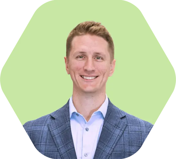Dave-headshot-lime green hex Dave Westerhaus smiling in a blue suit jacket against a light green background.